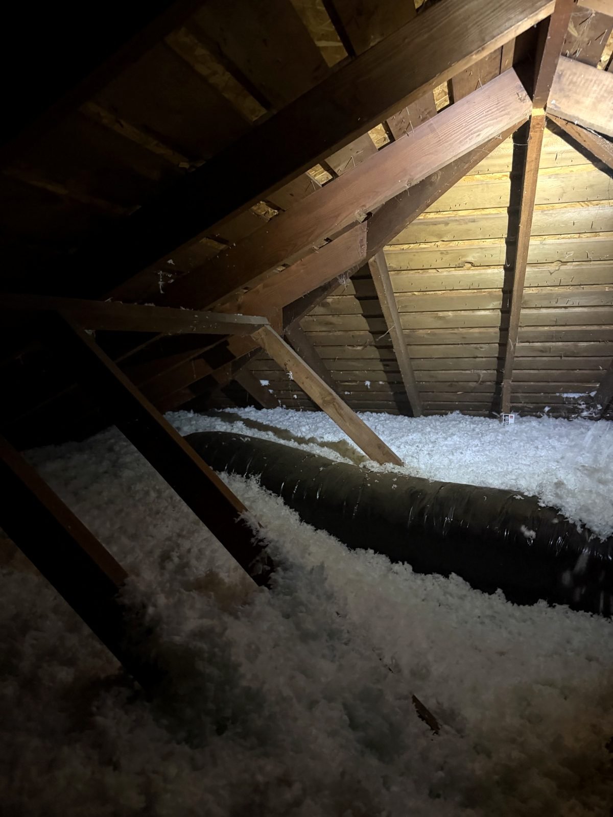 Same attic after AtticPro blown-in insulation &ndash; ductwork buried in a deep, even blanket