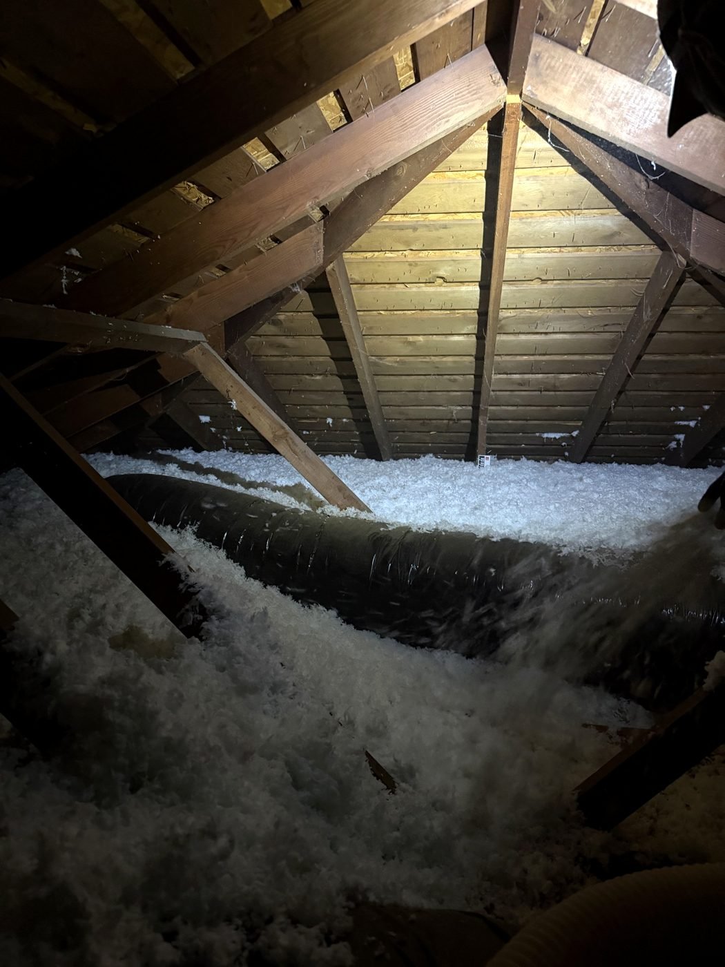 Attic ductwork surrounded by fresh blown-in insulation